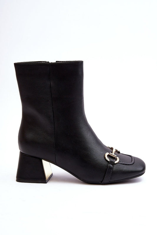 Close-up view of Step in Style's elegant eco leather heel boots, showcasing exquisite mirror detailing and sophisticated gold-tone accents.