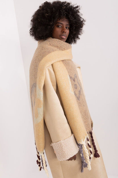 Sophisticated autumn-winter shawl scarf by AT, showcasing decorative stripes and luxurious tassels, adding warmth and style.