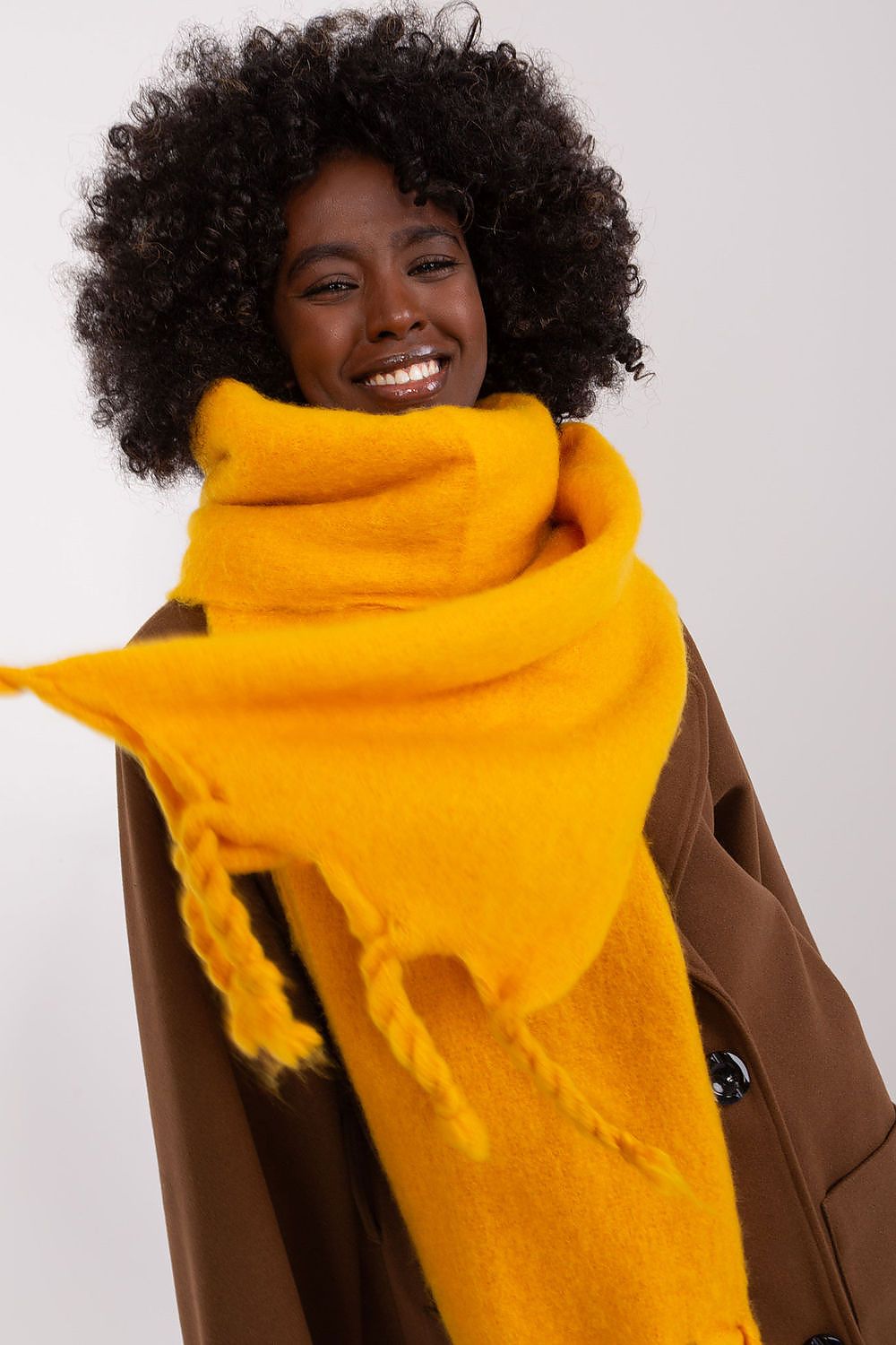 Sophisticated long scarf in premium polyester with tassels, designed by AT for luxurious warmth and effortless style.