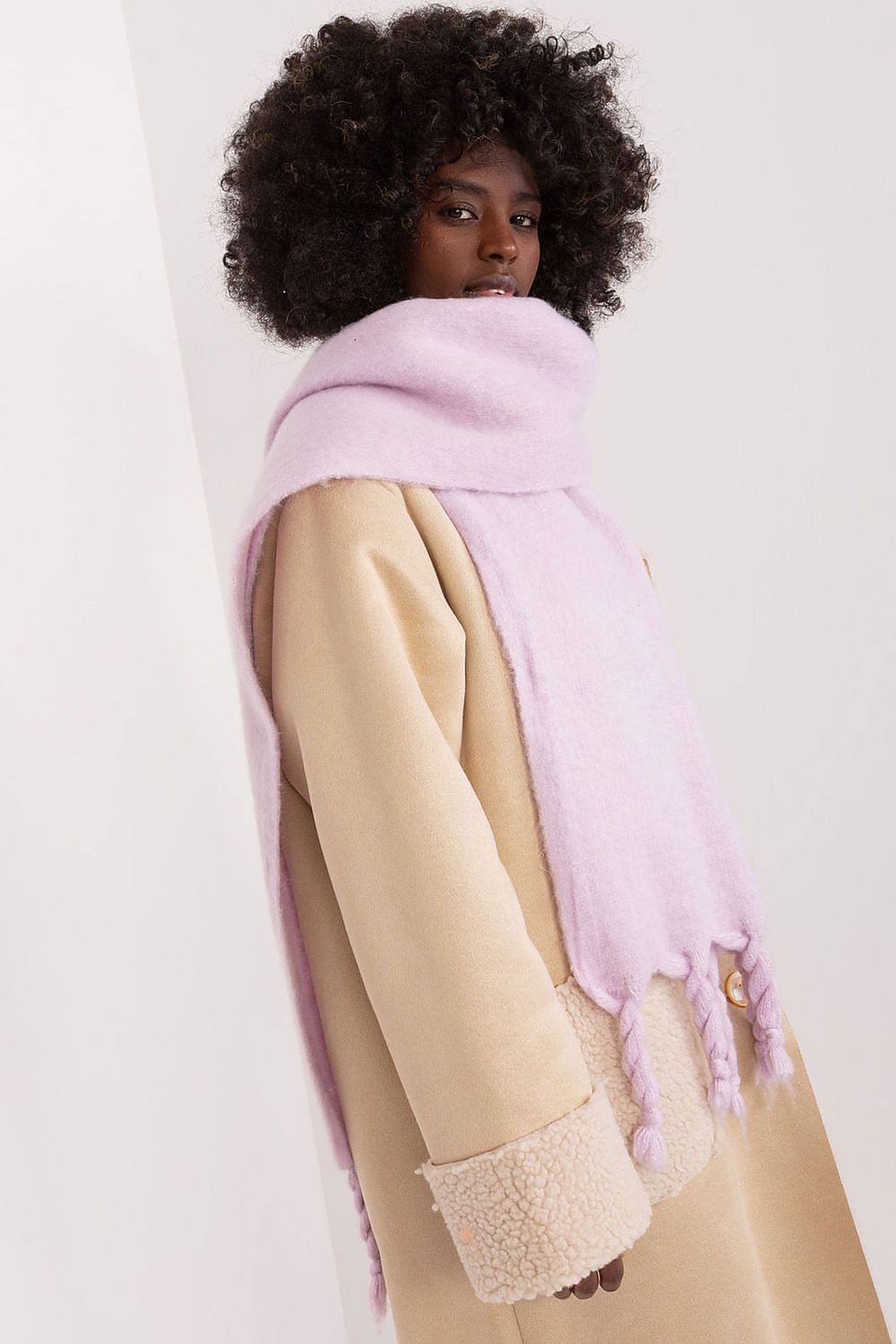 Fashionable long scarf by AT, elegantly wrapped around shoulders, enhancing any outfit with its luxurious touch during chilly weather.