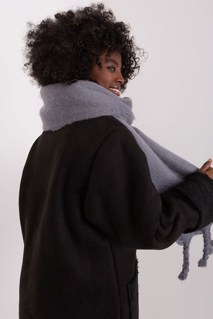 Versatile long scarf from AT, crafted from 100% polyester, showcasing chic tassels for a stylish winter look.