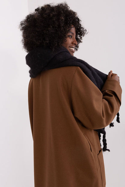 Trendy 100% polyester scarf by AT, demonstrating versatility and style for the fashionable winter wardrobe.