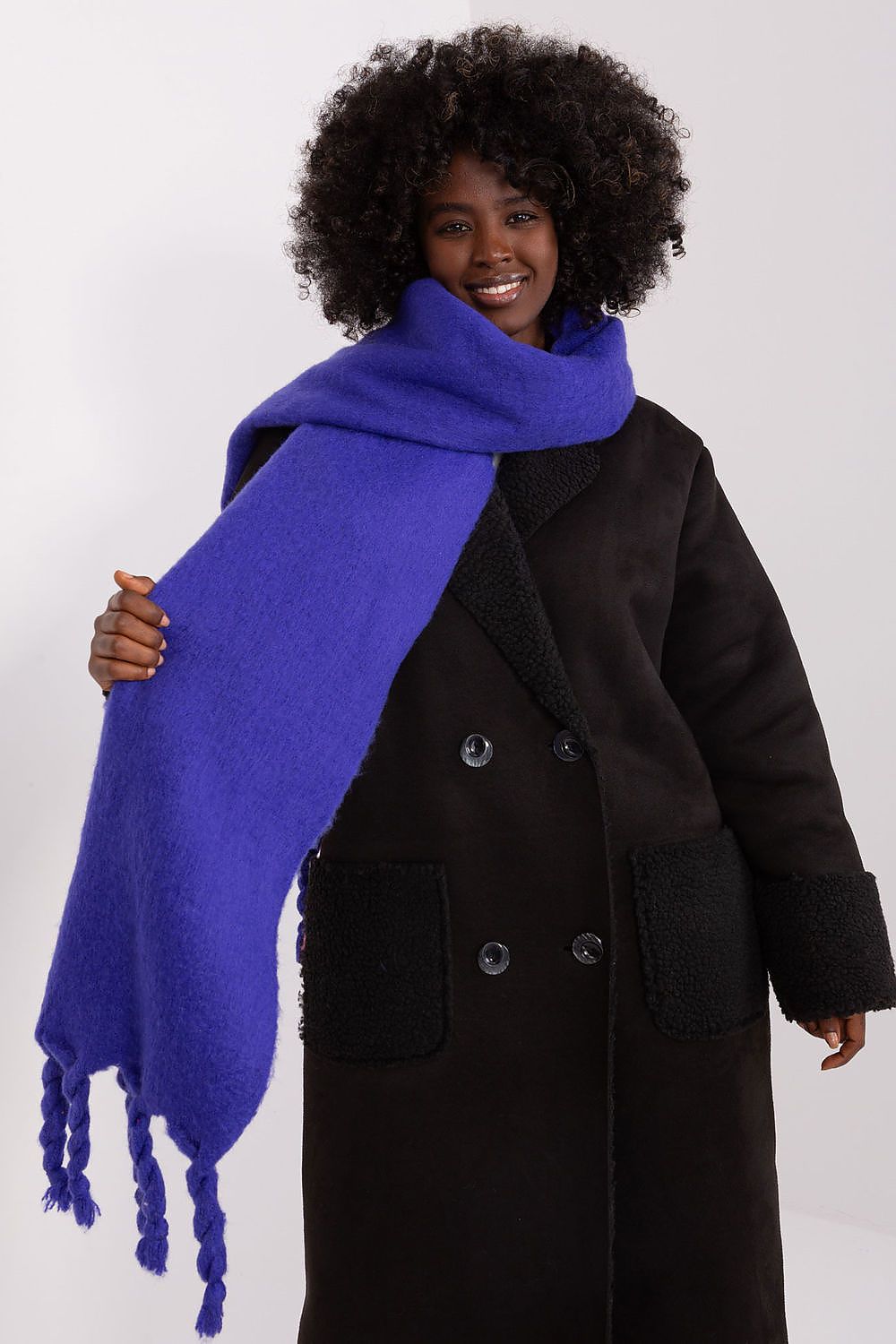 Elegant long scarf with tassels by AT, ideal for layering and adding warmth during colder seasons.