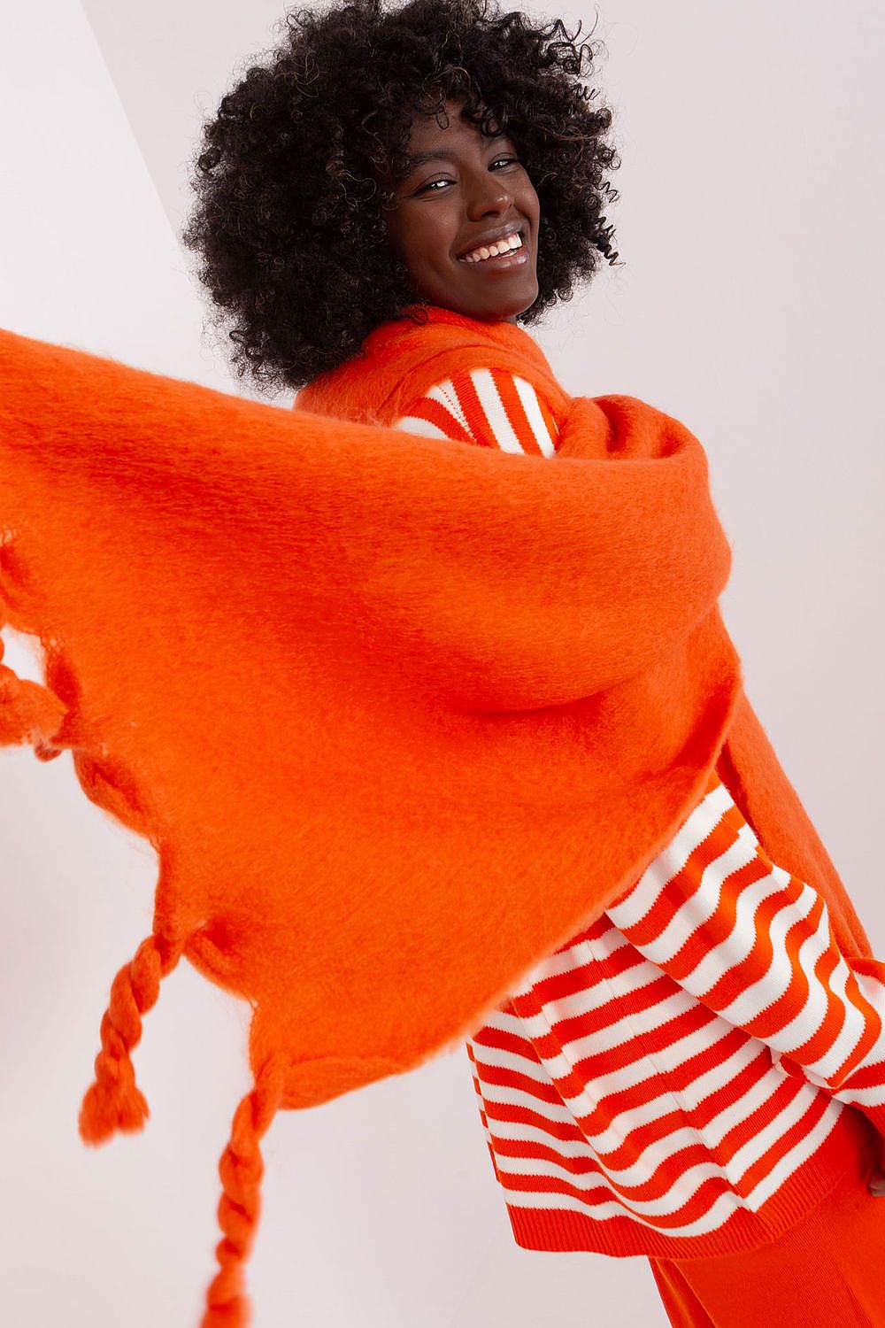 AT luxury scarf featuring a smooth texture and decorative tassels, perfect accessory for winter fashion.