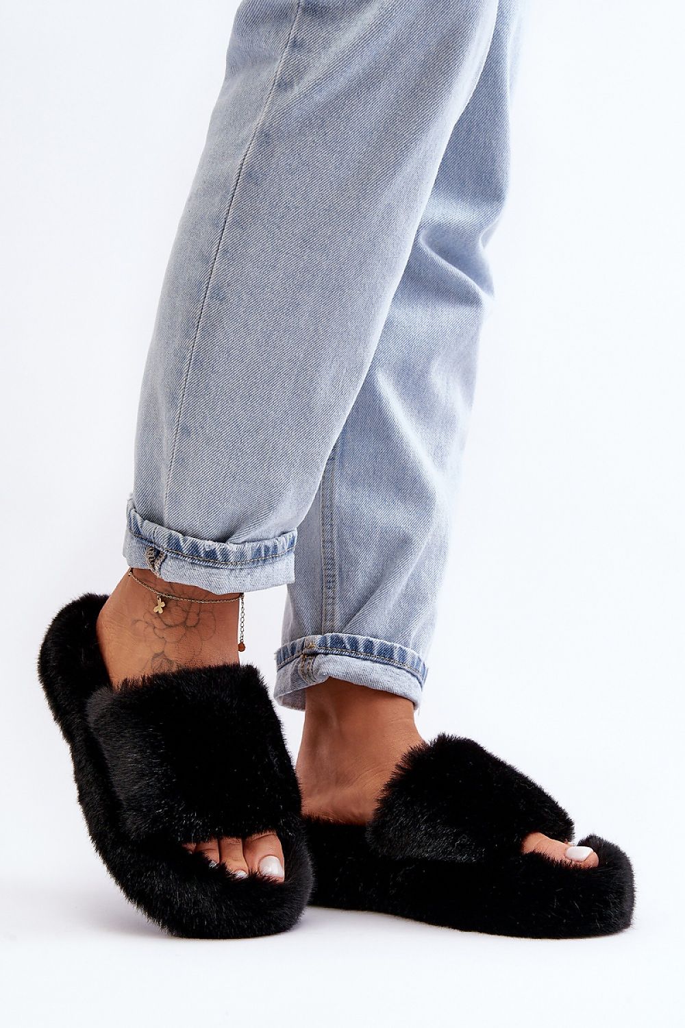 A pair of luxurious women's eco-friendly fur slippers by Step in Style, designed with a soft rubber sole for added comfort and warmth.