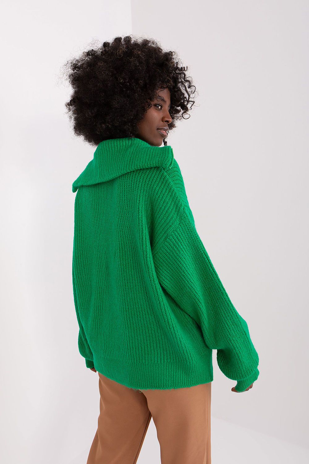 Detail shot of Badu's turtleneck sweater showcasing the stylish unbuttoned neck design and classic long sleeves.