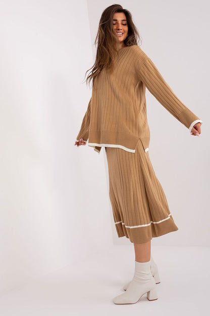 Close-up of the luxurious Badu knitted set showcasing the unique texture of the acrylic and wool blend, highlighting the contrasting details that add character to the elegant sweater and skirt duo.