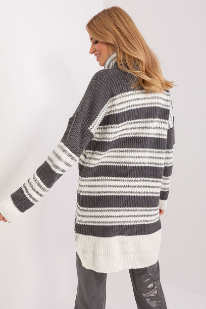 Elegant and fashionable oversized knit dress by Badu, characterised by its warm acrylic fabric, flattering extended back, and trendy long sleeves.