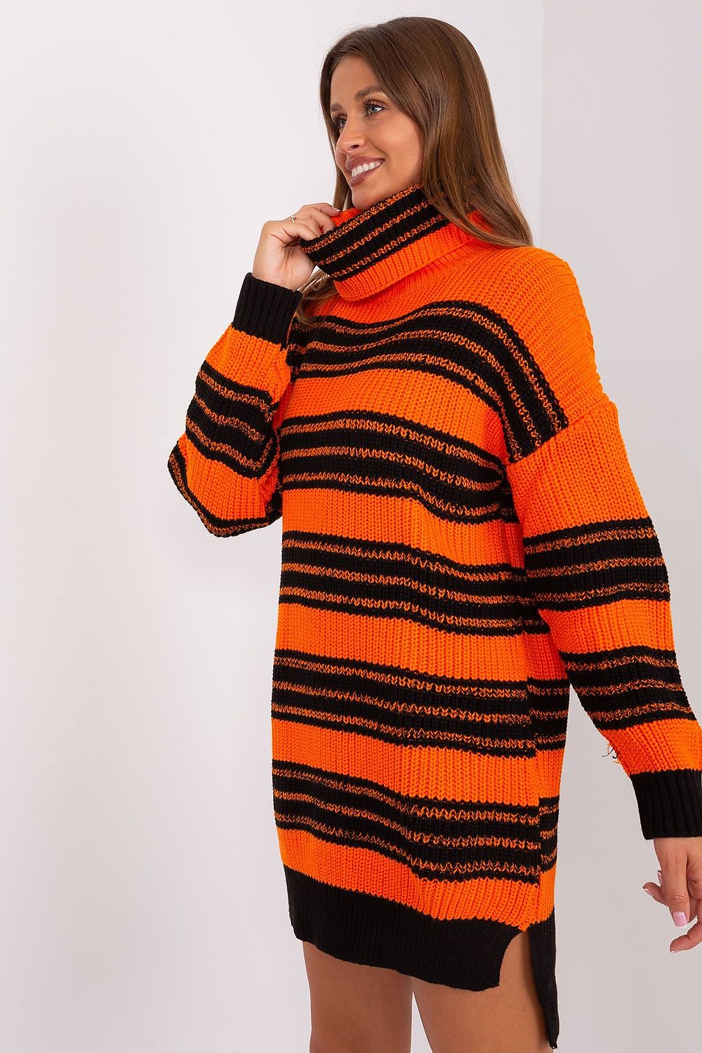 Stylish Badu knit dress with extended back design, perfect for a fashionable yet comfortable casual look with colourful stripes.