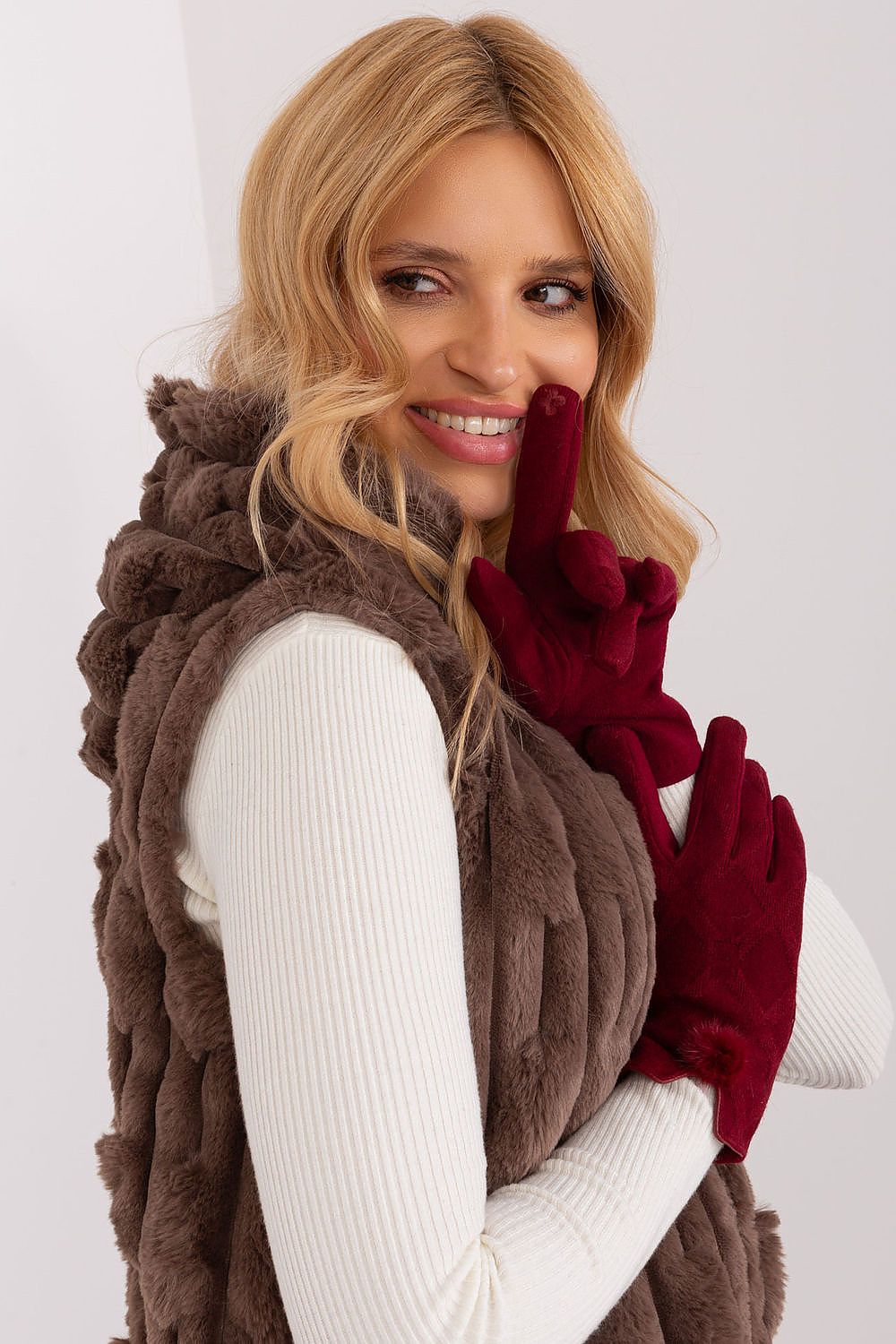 Close-up of AT women's insulated gloves showcasing the embroidered flower on the index finger for touchscreen use.