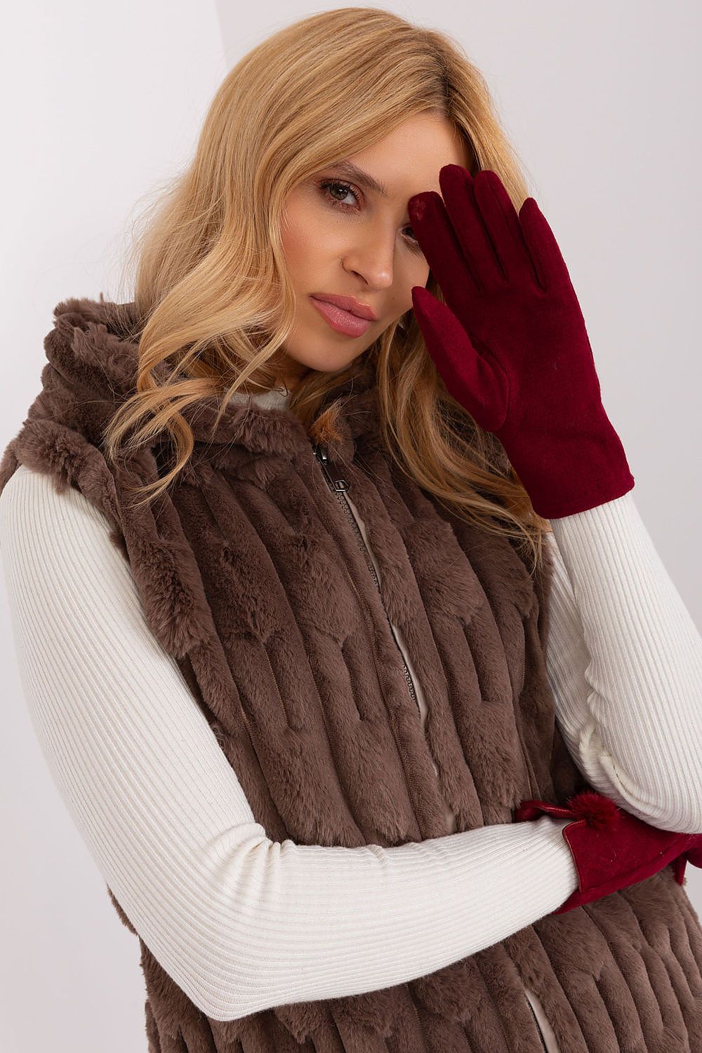 Luxurious women's insulated gloves from AT, displayed against a textured backdrop, demonstrating both style and functionality.