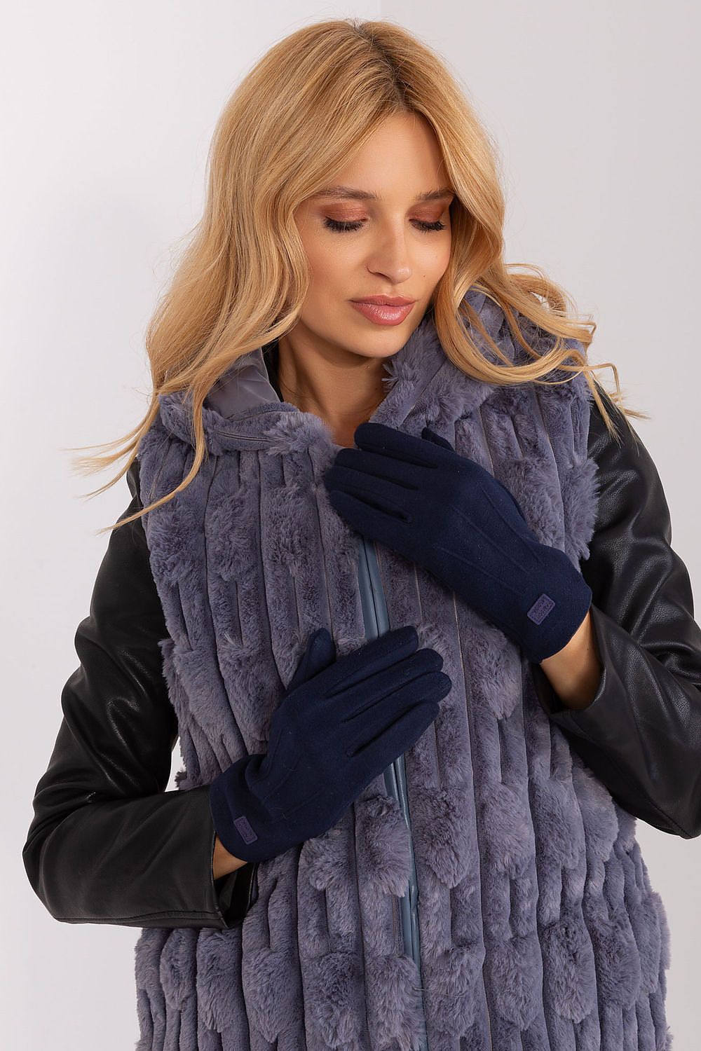 Close-up of luxurious insulated women's gloves by AT, showcasing the intricate embroidered flower and stylish wrist patches.