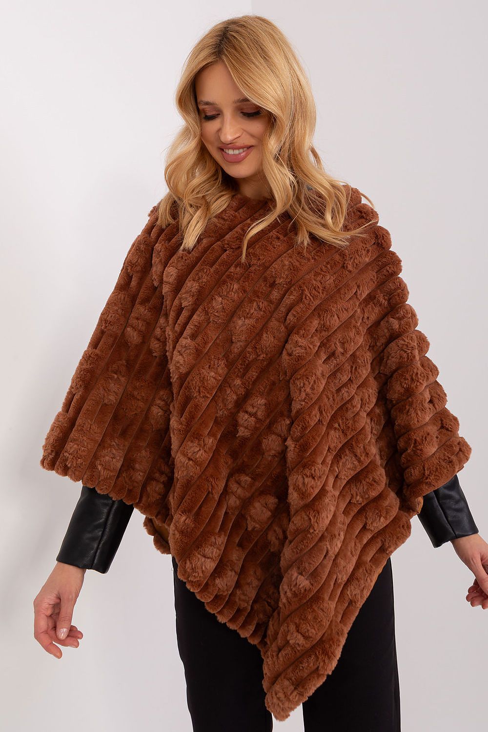 Elegant poncho design by AT presenting a unique combination of texture and comfort for fashionable looks.