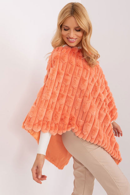AT's luxurious poncho displayed in a versatile setting, ideal for casual outings and spontaneous coffee dates.