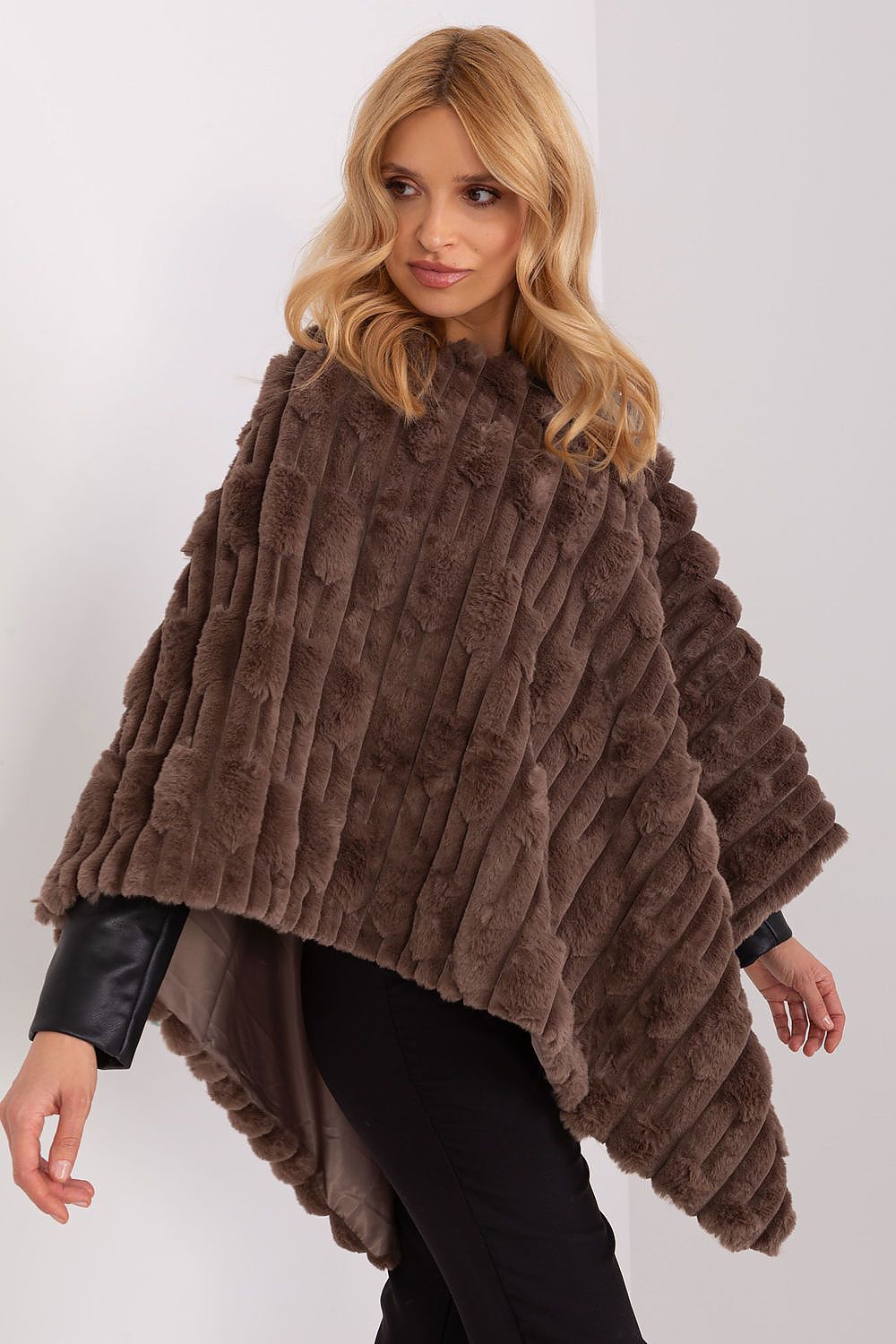 AT's luxurious poncho in 100% polyester, highlighting its unique material texture and comfortable lining for a chic look.