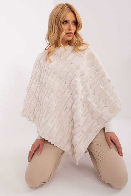 Elegant fold of the luxurious poncho by AT, emphasizing its soft drape and high-quality polyester, a must-have statement piece for your wardrobe.