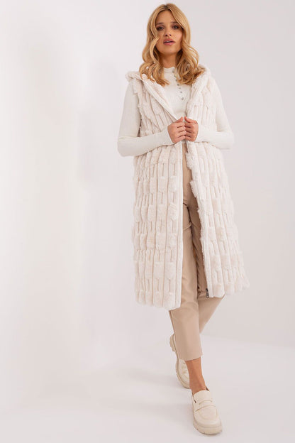 Elegant women's fur vest by AT, showcased in a chic winter outfit, highlighting its knee-length cut and functional pockets.
