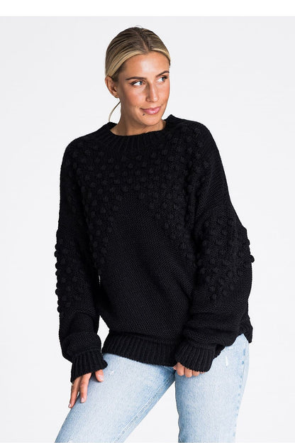 Elegant Figl long sleeve sweater featuring decorative pom-poms and ribbed detailing, crafted from a soft acrylic blend, perfect for luxurious winter styling.