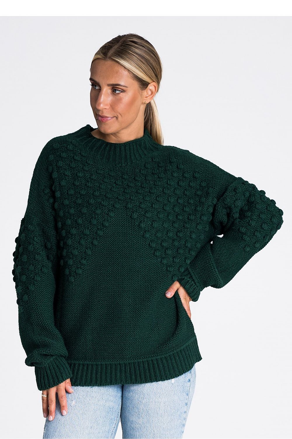 Stylish presentation of the Figl long sleeve sweater, emphasizing the luxurious feel of the acrylic blend and the trendy pom-pom embellishments.