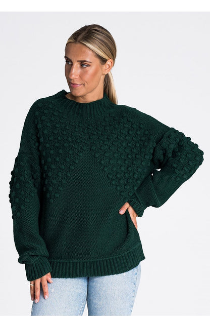 Stylish presentation of the Figl long sleeve sweater, emphasizing the luxurious feel of the acrylic blend and the trendy pom-pom embellishments.