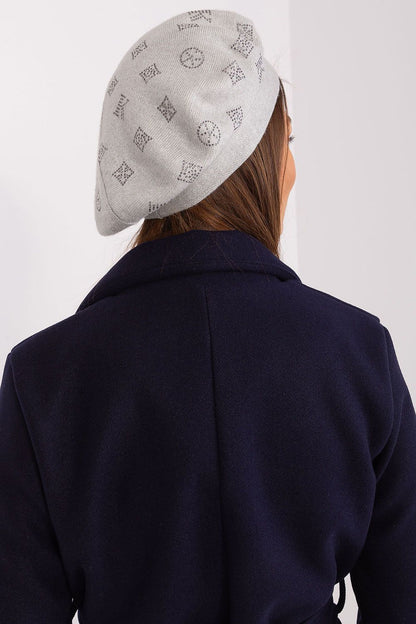 Elegant knitted beret with rhinestone details, designed by AT, made of 50% acrylic, 30% cotton, and 20% cashmere for a luxurious feel.
