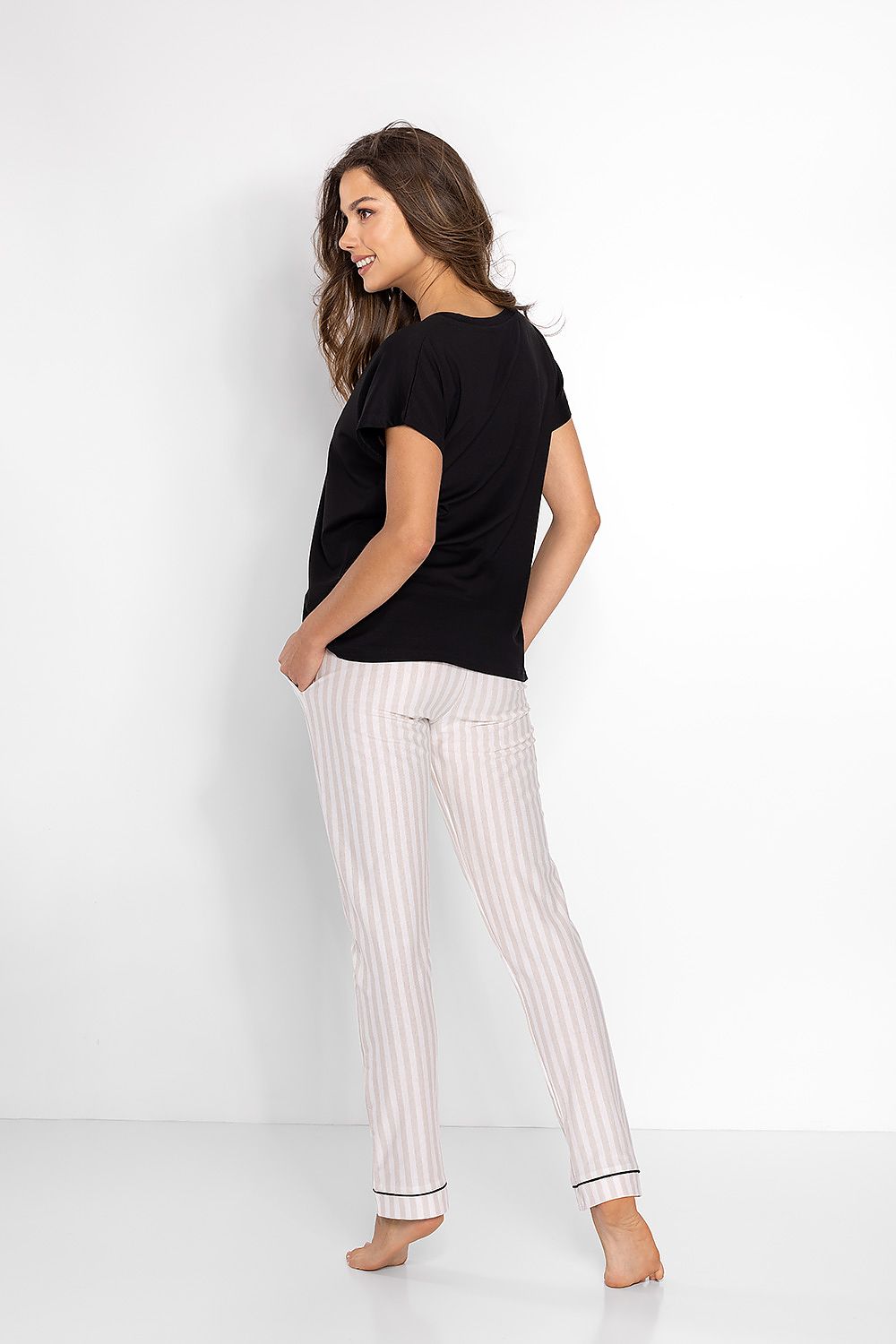 Elegant Women's Pyjama Set from Momenti Per Me, showcasing the soft fabric and sophisticated striped design of the elastic pants paired with a heart neckline blouse.