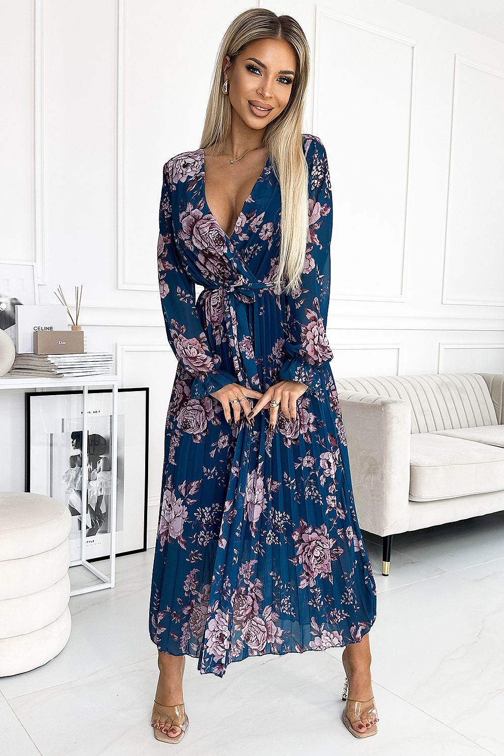 Luxurious Numoco dress in chiffon, elegantly pleated with a flattering envelope neckline, designed with vibrant floral motifs, suitable for any sophisticated event.