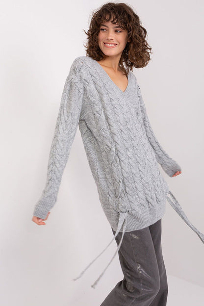 Luxurious women's acrylic wool sweater by Badu featuring a decorative tie and elegant plaid texture.