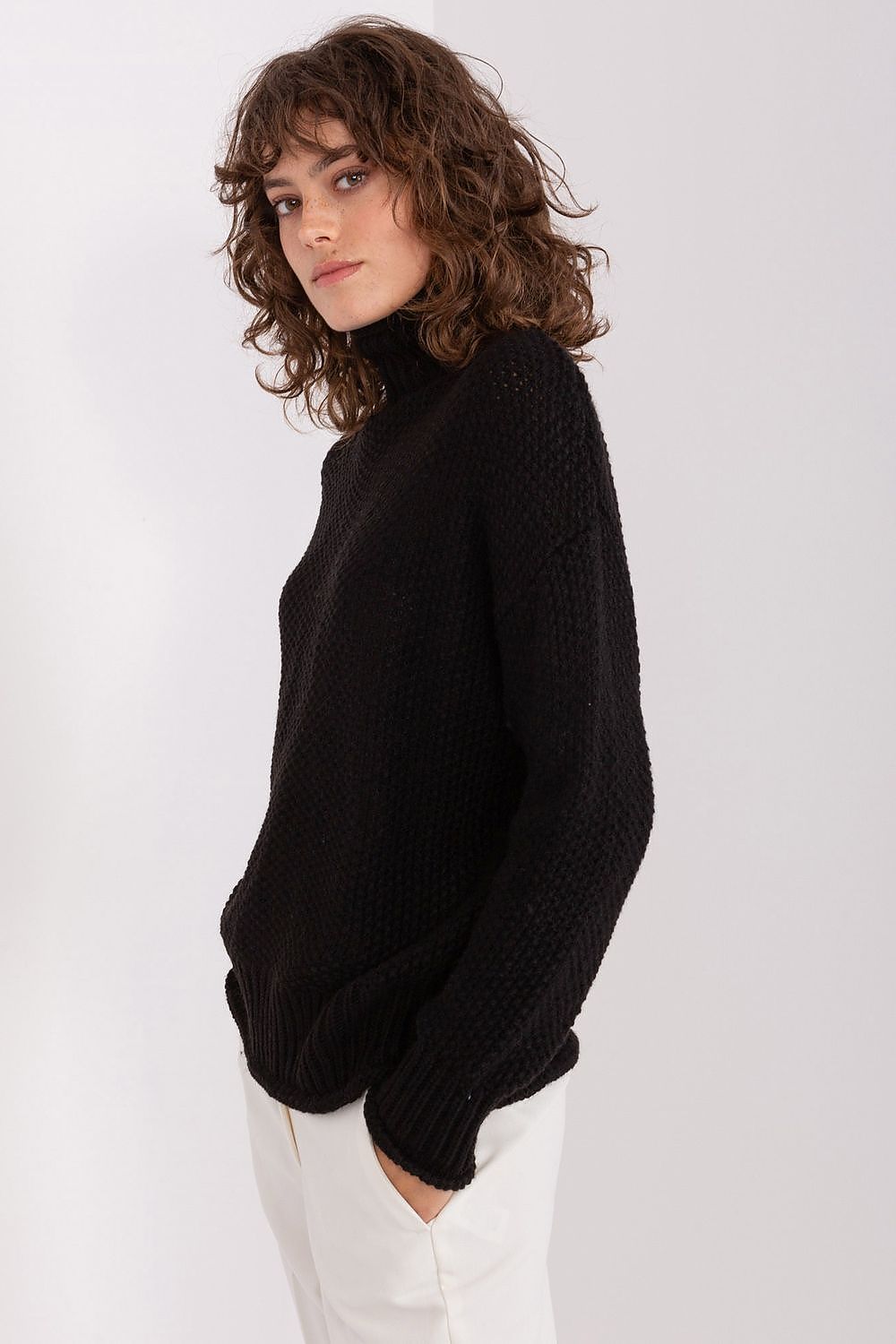 Badu's Elegant Women's Turtleneck Sweater displayed with a chic jacket, exemplifying its versatility for all occasions.