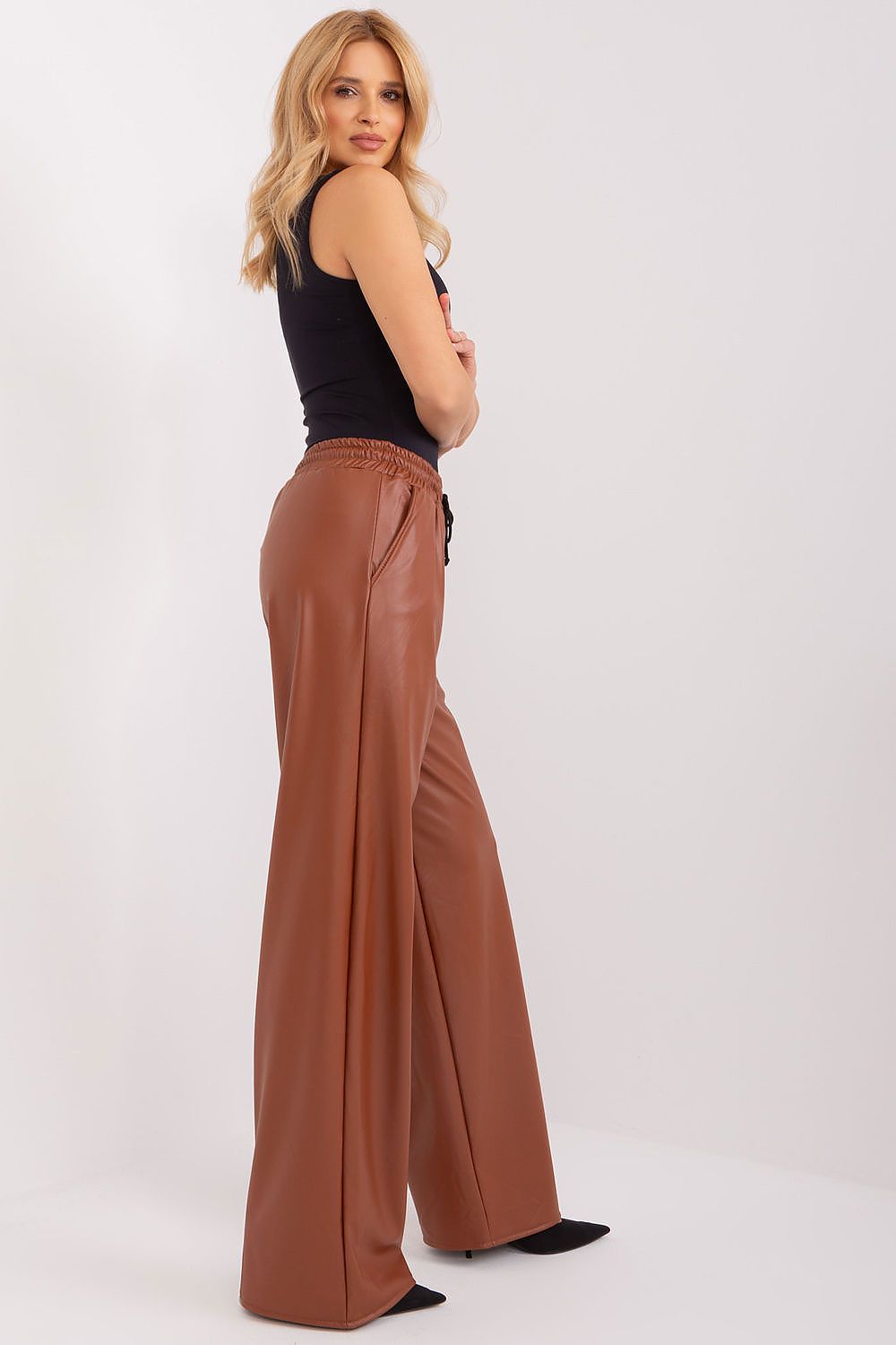 Luxurious view of Lakerta's ecological leather trousers with high waist and binding, designed for comfort and style.
