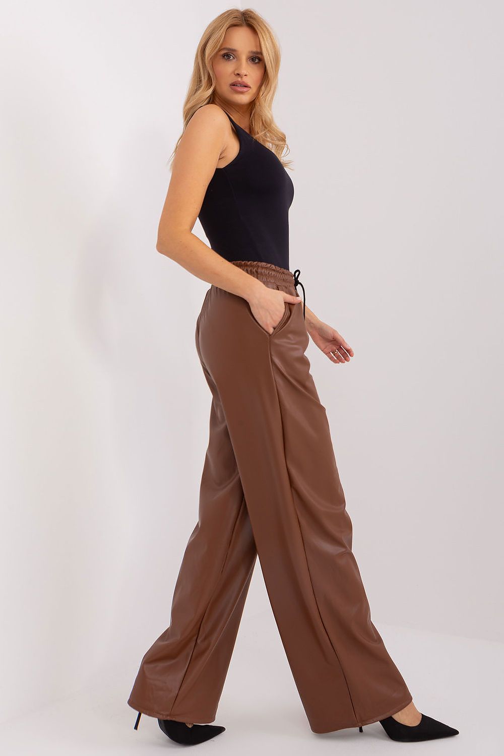 Luxury high-waisted ecological leather trousers by Lakerta, featuring insulation and stylish slip pockets, perfect for versatile occasions.