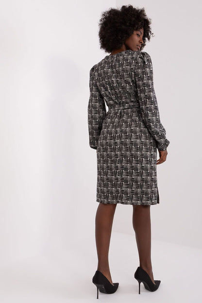 Elegant Lakerta geometric pattern daydress featuring a heart neckline and tie belt, designed for sophistication and style.