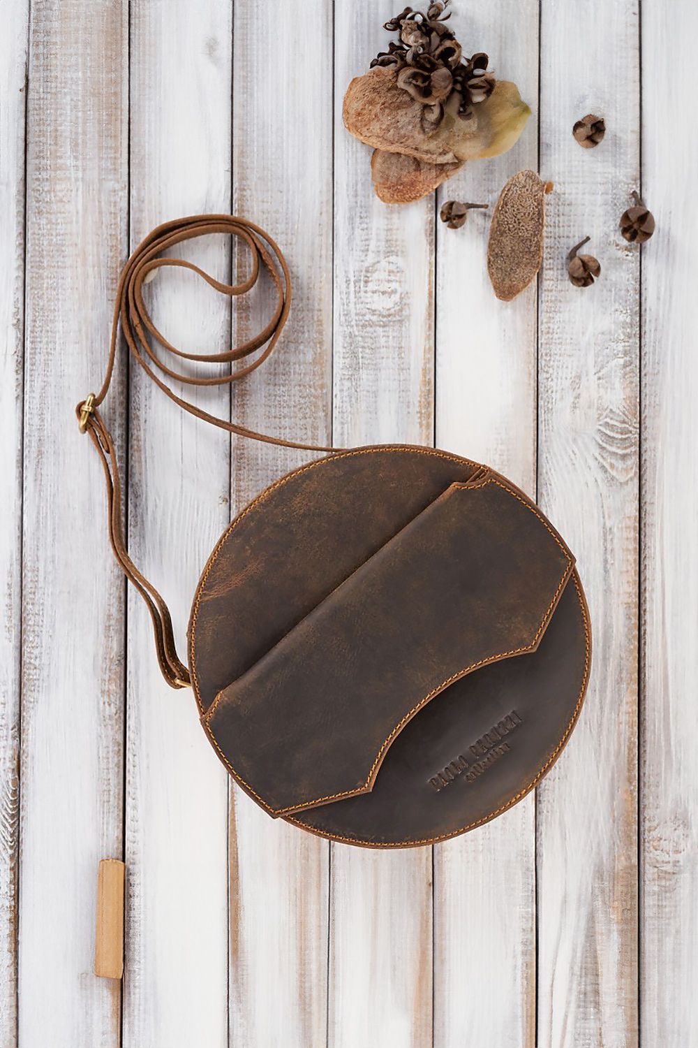 Galanter Vintage Style Leather Handbag displayed alongside women's trinkets, illustrating its practical size and chic appeal.