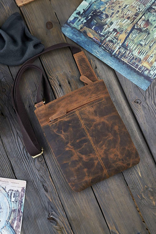 Close-up of Galanter shoulder bag featuring aged natural leather, slip front pocket, and back zipper pocket, exemplifying luxurious practicality.