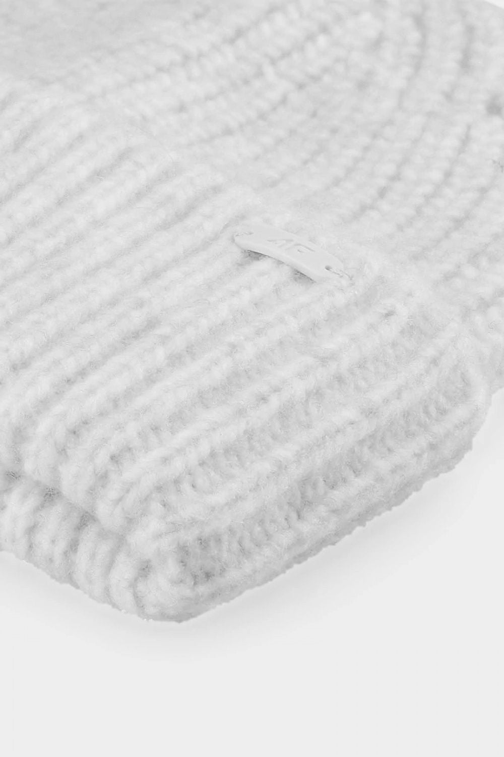 Close-up view of the luxurious 4F winter beanie in a plush grey hue, showcasing its texture and premium quality for winter protection.