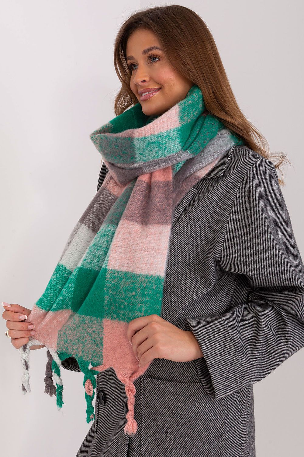 Fashionable long plaid scarf with delicate tassels by AT, designed for comfort and elegance in cooler seasons.