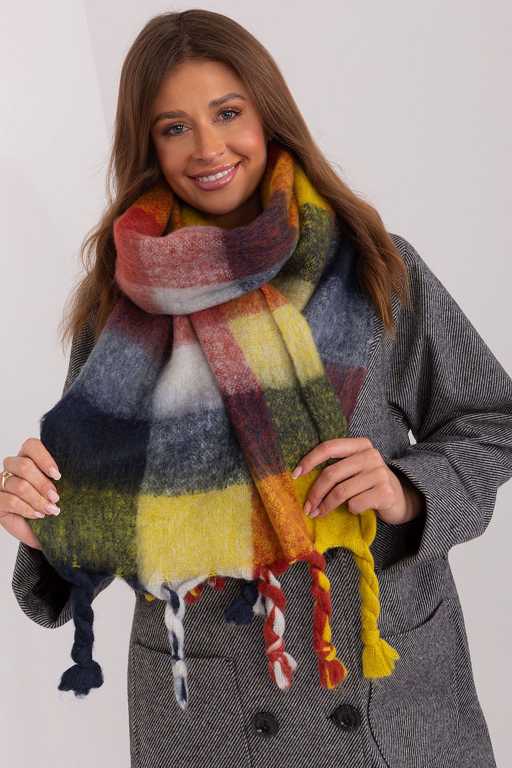 Elegant long plaid scarf featuring vibrant colours and tassels, designed by AT, perfect for chic layering in colder seasons.