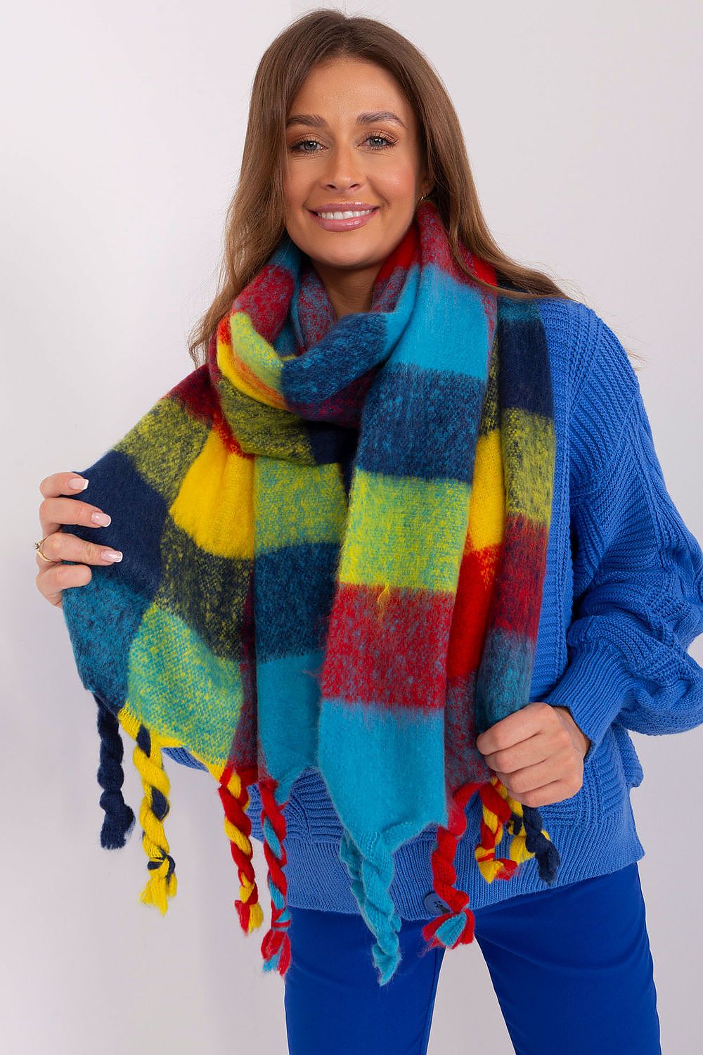 Elegant view of the AT plaid long scarf featuring colourful patterns and tassels, ideal for adding a touch of sophistication to seasonal attire.