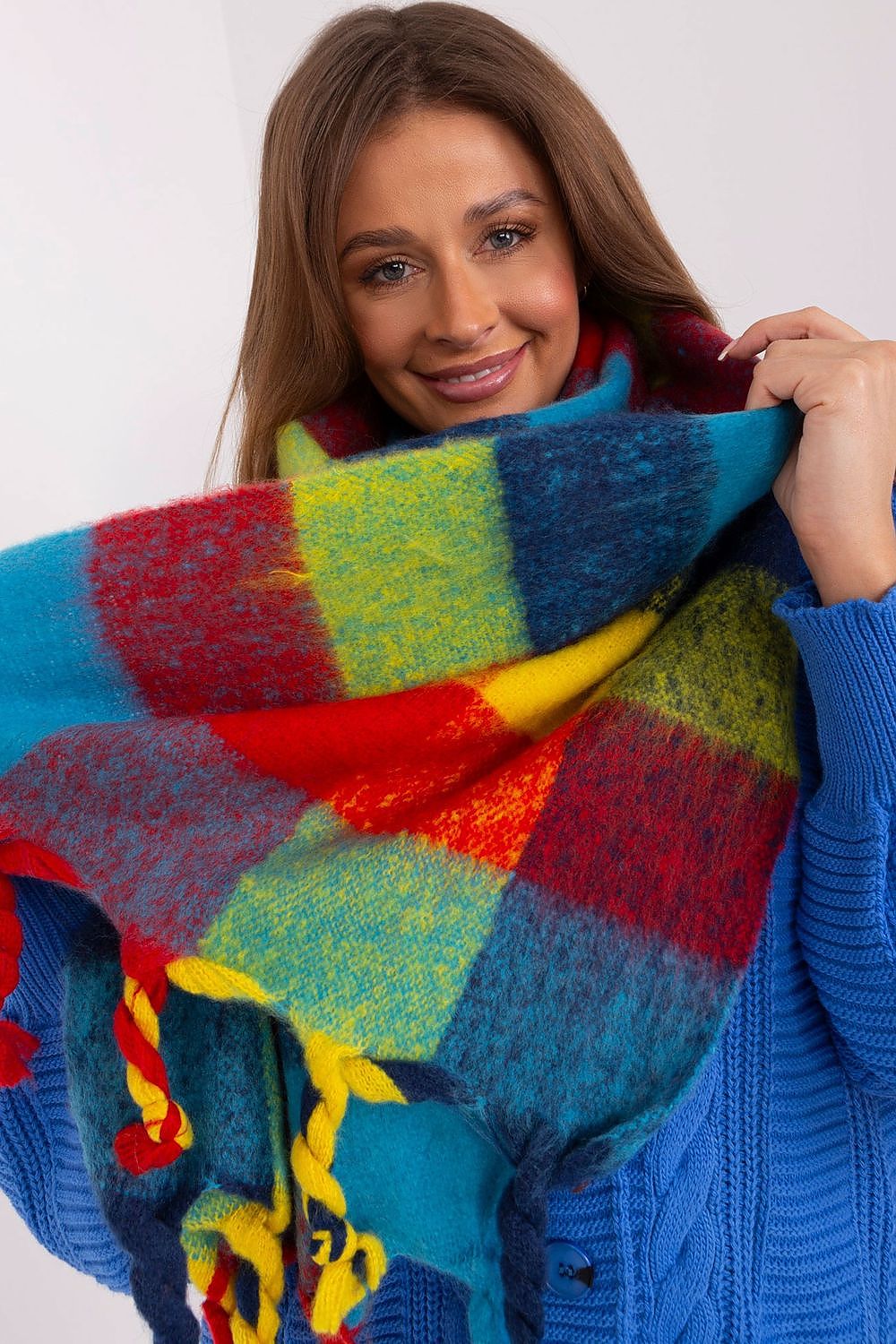 Fashionably draped AT plaid long scarf with tassels, capturing its vibrant colours and luxurious texture, an essential for stylish winter layering.