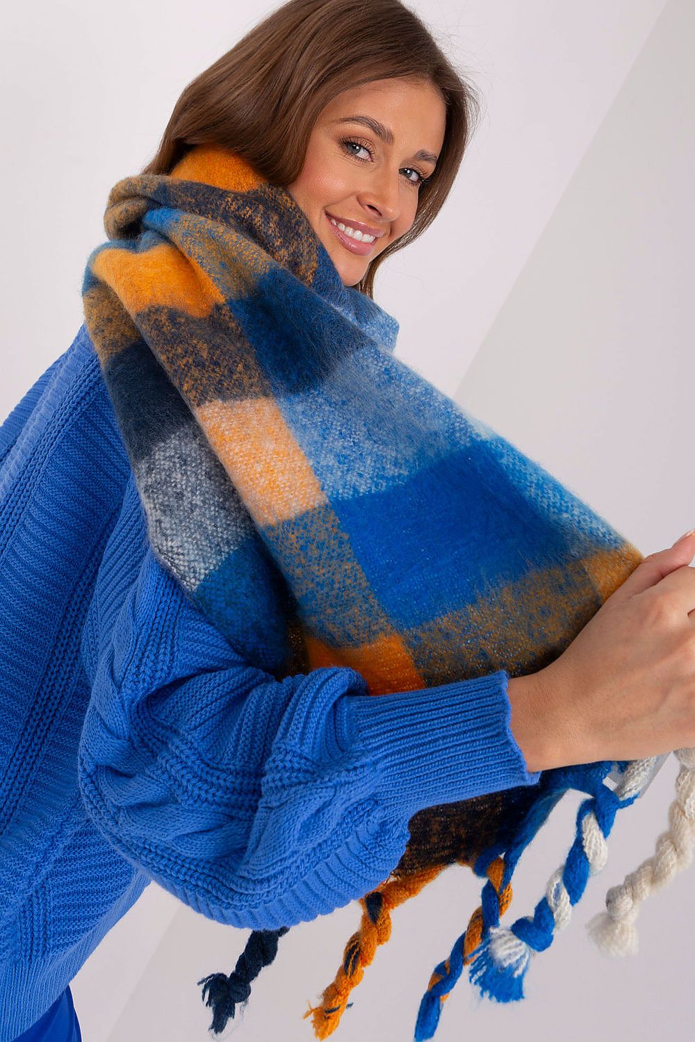 AT luxurious colourful plaid scarf, designed for sophisticated fall and winter fashion, featuring a soft polyester texture and flattering tassels.