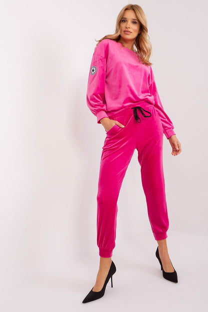 Chic tapered pants from Italy Moda with drawstring hem and practical pockets, part of an elegant velour knit set.