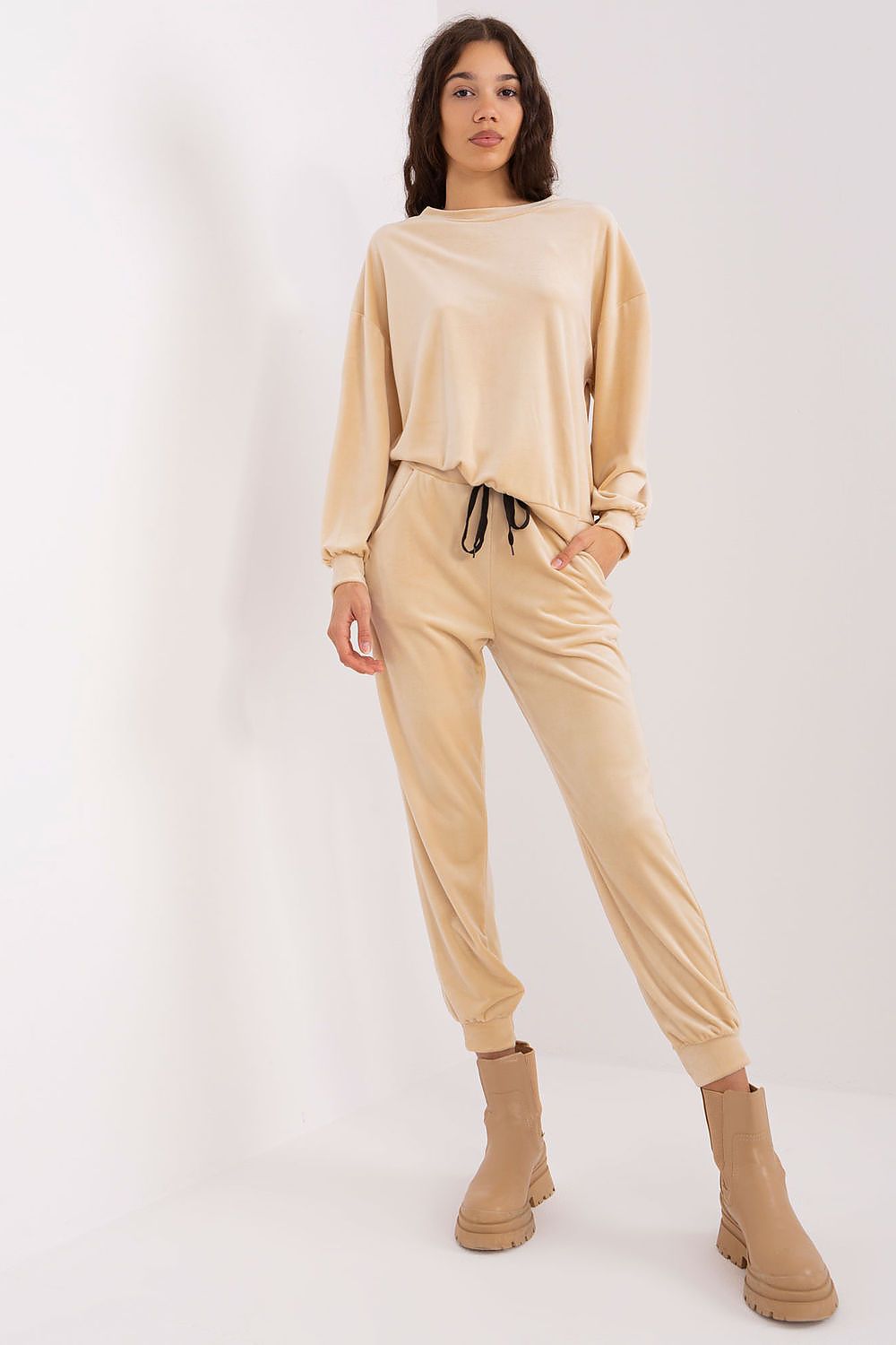 Elegant close-up of Italy Moda's velour knit set showcasing detailed craftsmanship and feminine design elements.