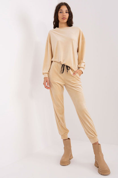 Elegant close-up of Italy Moda's velour knit set showcasing detailed craftsmanship and feminine design elements.