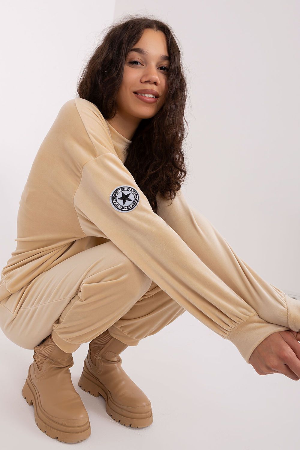 Complete Italy Moda velour knit sweatshirt and tapered pants ensemble, exemplifying luxury and comfort for various occasions.