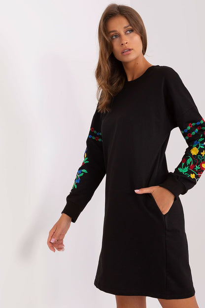 Chic sweatshirt dress in rich emerald green by Rue Paris, designed with stylish embroidered details and convenient side pockets.