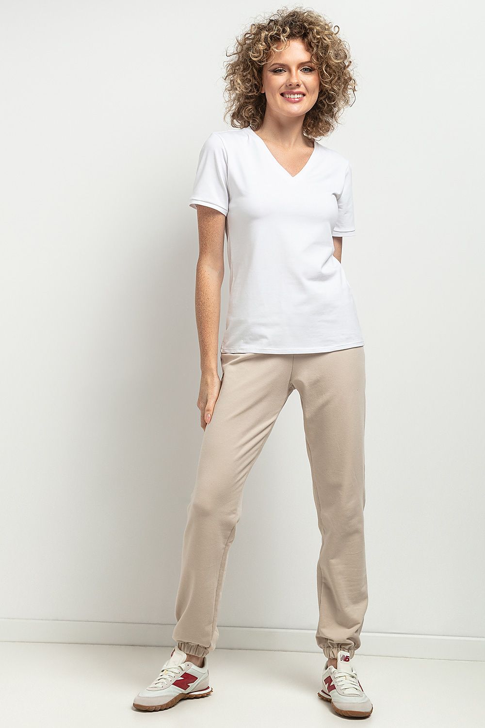 Stylish Tessita blouse with a slim-fit silhouette and feminine V neckline, crafted from eco-friendly OEKO-TEX certified cotton knit for luxurious comfort.