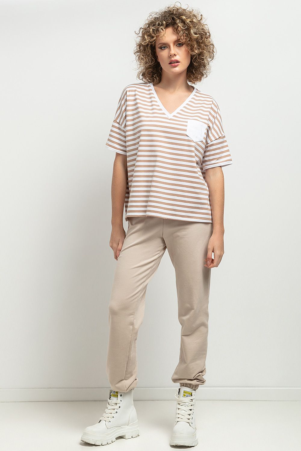 Tessita Luxurious Loose Blouse featuring a feminine V neckline with elegant decorative pleats in a stylish striped design.