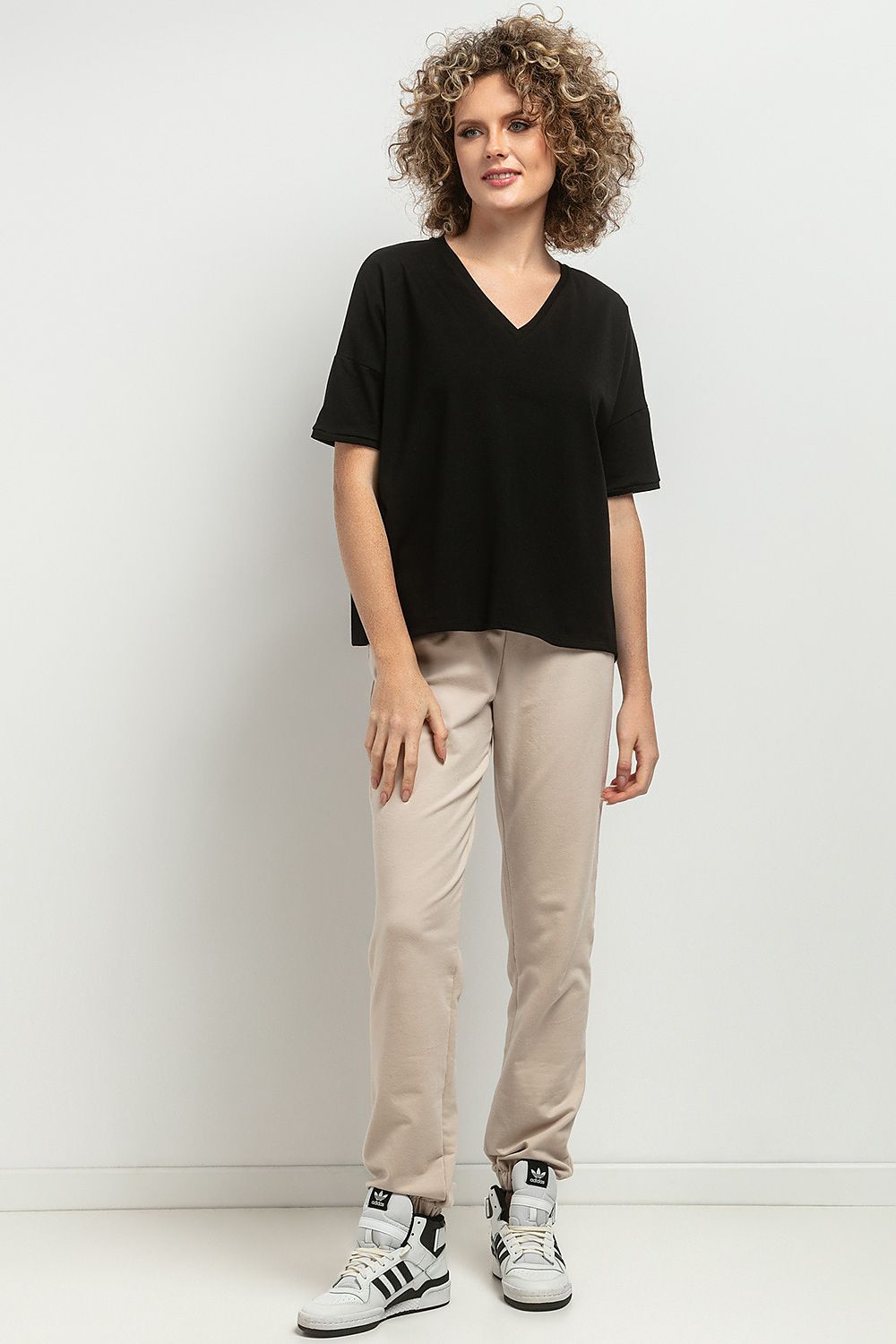 Close-up of the Tessita Loose Blouse showcasing the intricate decorative pleats and soft knitted fabric, emphasizing luxury and quality.