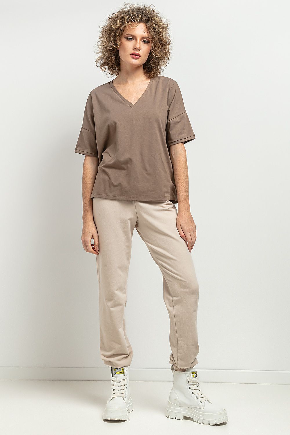 Side view of Tessita's Loose Blouse, highlighting its feminine silhouette and stylish cuffed sleeves, ideal for both casual and elegant occasions.