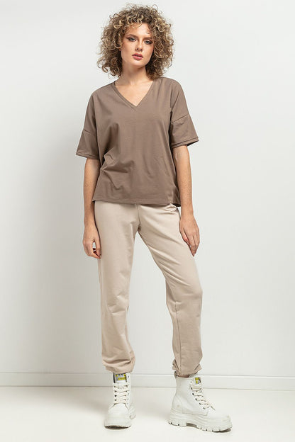 Side view of Tessita's Loose Blouse, highlighting its feminine silhouette and stylish cuffed sleeves, ideal for both casual and elegant occasions.